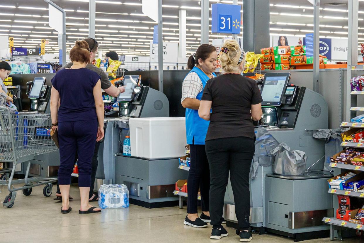 Customers check out at a Walmart store.