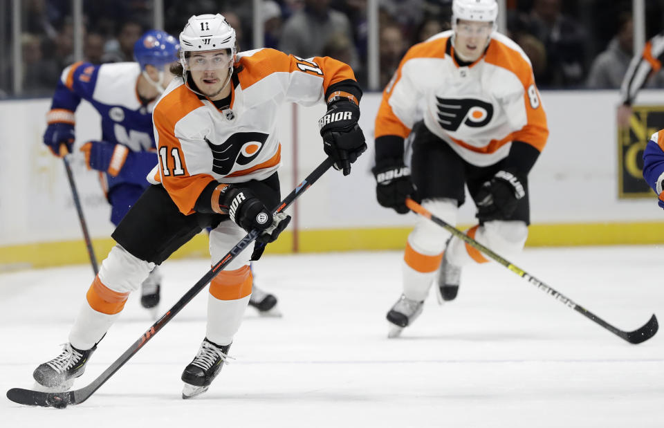 Philadelphia Flyers right wing Travis Konecny (11) skates downice with the puck during the first period of an NHL hockey game against the New York Islanders, Sunday, March 3, 2019, in Uniondale, N.Y. (AP Photo/Kathy Willens)