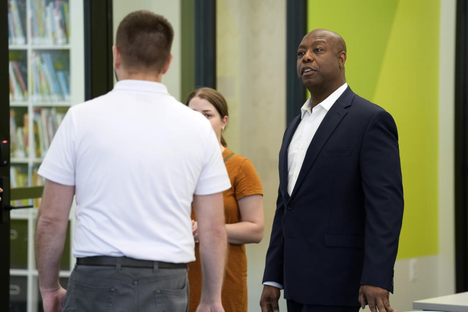 Sen. Tim Scott, R-S.C., tours the Marion Public Library, Wednesday, April 12, 2023, in Marion, Iowa. Scott on Wednesday launched an exploratory committee for a 2024 GOP presidential bid, a step that comes just shy of making his campaign official. (AP Photo/Charlie Neibergall)