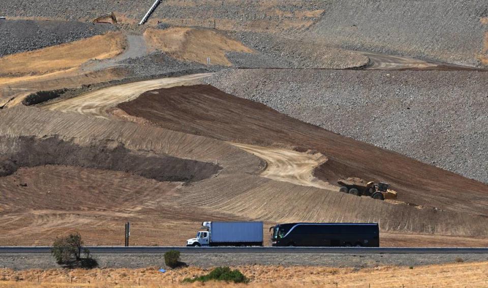 Traffic passes along Highway 152, bottom, as construction continues in the first phase of improvements at the B.F. Sisk Dam west of Los Banos Friday, Aug. 16, 2024.