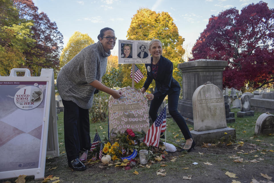 Lisa Walden, left and Steph Kula of Rochester place their 'I voted' stickers on the grave of women's suffrage leader Susan B. Anthony on U.S. election day at Mount Hope Cemetery in Rochester, New York, on Nov. 8