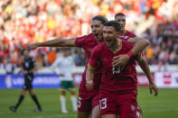Serbia's Milos Veljkovic, centre, celebrates after scoring his side's opening goal during the Euro 2024 group G qualifying soccer match between Serbia and Bulgaria at the Dubocica stadium in Leskovac, Serbia, Sunday, Nov. 19, 2023. (AP Photo/Darko Vojinovic)