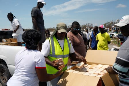 A volunteer delivers food during an evacuation operation after Hurricane Dorian hit the Abaco Islands in Treasure Cay