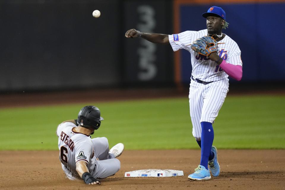 New York Mets' Ronny Mauricio (10) throws out Arizona Diamondbacks' Evan Longoria at first base after forcing out Jace Peterson (6) on a double play during the sixth inning of a baseball game Tuesday, Sept. 12, 2023, in New York. (AP Photo/Frank Franklin II)