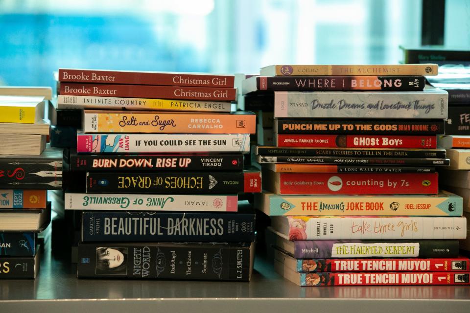 Piles of books rest on a shelf at the 8th Teen Bookfest By the Bay at American Bank Center Saturday, Feb. 4, 2023. Readers who attended three or six workshops were able to get a free book or two.