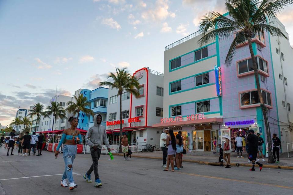 Tourists stroll along Ocean Drive in this spring break file photo from March 22, 2021.