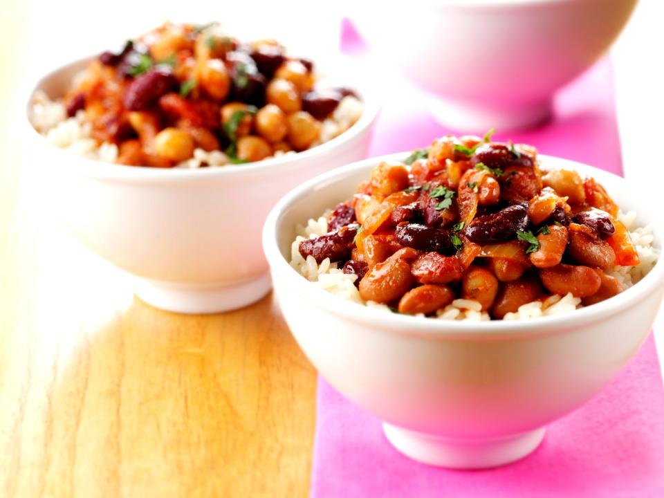 two bowls of bean chili over rice