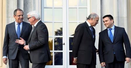 REFILE - Foreign ministers (L-R) Sergei Lavrov of Russia, Frank-Walter Steinmeier of Germany, Laurent Fabius of France and Pavlo Klimkin of Ukraine leave for their meeting after a picture opportunity at the German foreign ministry's Villa Borsig at lake Tegel in Berlin, Germany September 12, 2015. REUTERS/Tobias Schwarz/Pool