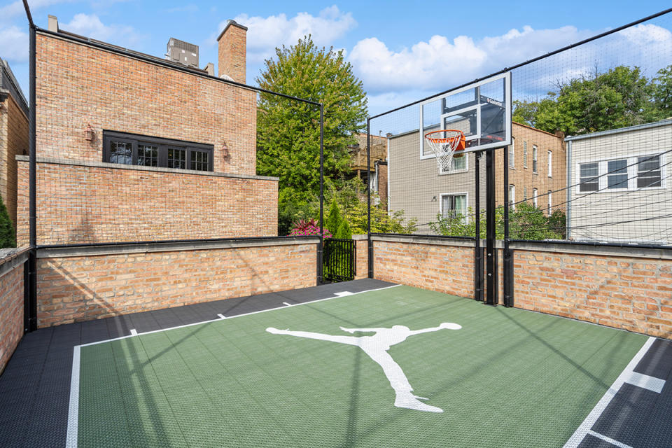 The sport court sits atop a detached two-car garage.