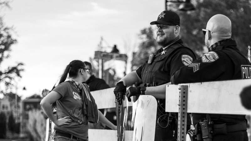 Police officers standing near a barricade