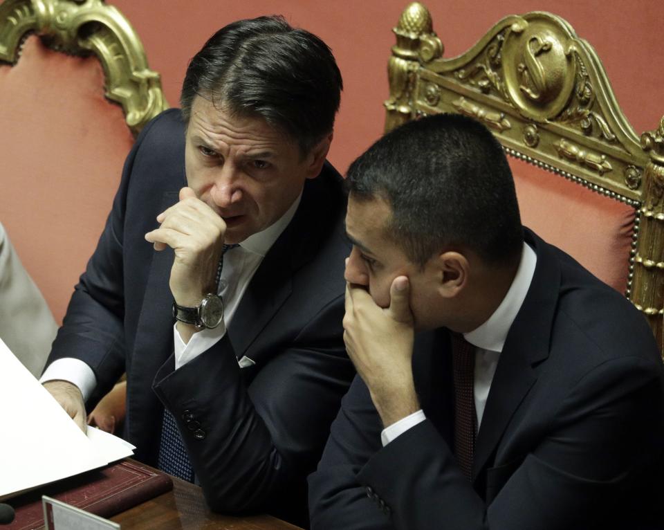 Italian Premier Giuseppe Conte, left, shares a word with Foreign Minister Luigi Di Maio at the Senate ahead of a second confidence vote on his coalition government, in Rome, Tuesday, Sept. 10, 2019. Conte on Monday won the first of two mandatory confidence votes on his four-day-old coalition of rival parties, after a day of fielding insults during a boisterous Parliament session from an opposition outraged that Italy got a new government instead of a new election. (AP Photo/Andrew Medichini)