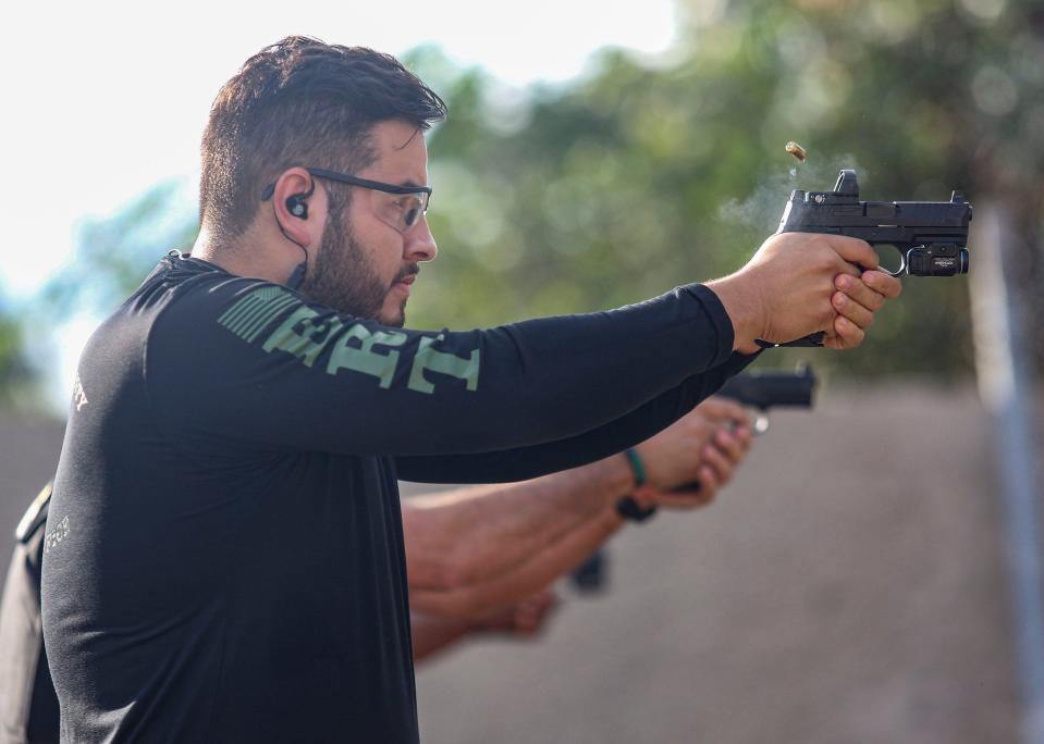 Corporal Jose Avianeda demonstrates using a 9mm FN 509, Monday, Dec. 4, 2023, after Indian River County Sheriff Eric Flowers announcement of a department-wide switch to the weapon from their previous handgun SIG Sauer p320.