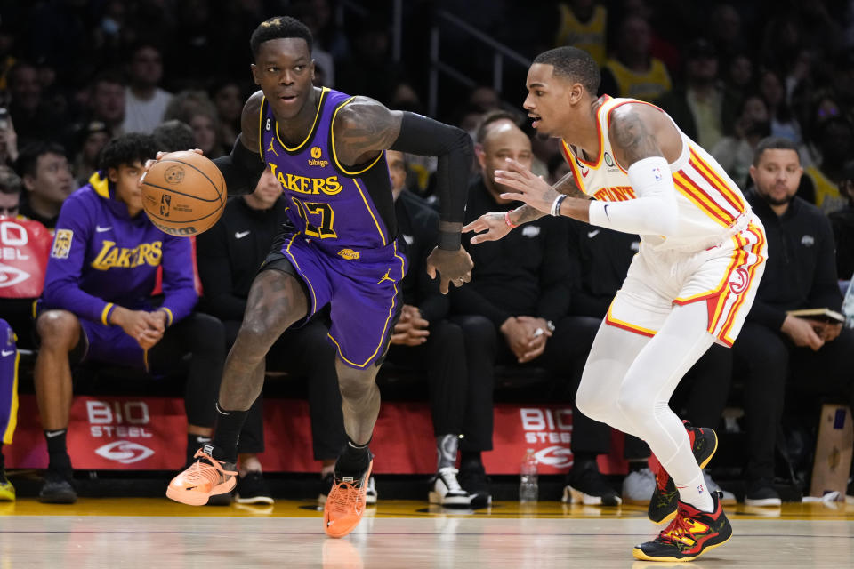 Los Angeles Lakers' Dennis Schroder (17) drives past Atlanta Hawks' Dejounte Murray during the first half of an NBA basketball game Friday, Jan. 6, 2023, in Los Angeles. (AP Photo/Jae C. Hong)