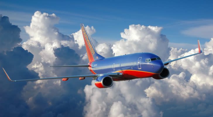 a southwest airline stocks (LUV) jet flying above the clouds