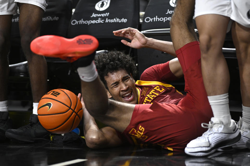 Iowa State guard Curtis Jones (5) falls into the Central Florida bench after chasing down a loose ball during the second half of an NCAA college basketball game, Saturday, March 2, 2024, in Orlando, Fla. (AP Photo/Phelan M. Ebenhack)