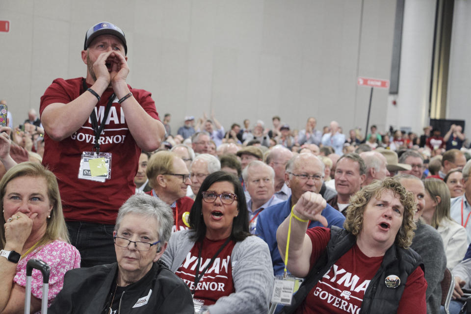 Supporters of Utah state Rep. Phil Lyman, a candidate for governor, and other Republican delegates, boo incumbent Gov. Spencer Cox as he takes the stage at the Utah Republican Party Convention, Saturday, April 27, 2024, in Salt Lake City. (AP Photo/Hannah Schoenbaum)