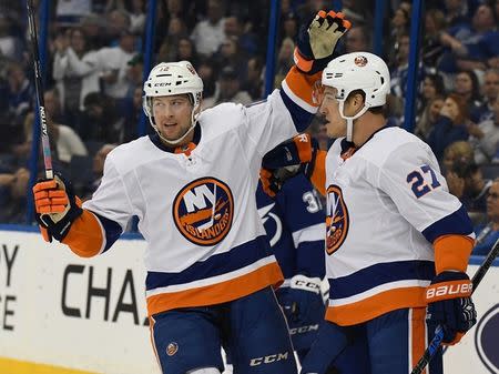 Nov 18, 2017; Tampa, FL, USA; New York Islanders right wing Josh Bailey (12) celebrates after New York Islanders left wing Anders Ladd (27) scored a goal in the first period in the first period against the Tampa Bay Lightning at Amalie Arena. Mandatory Credit: Jonathan Dyer-USA TODAY Sports