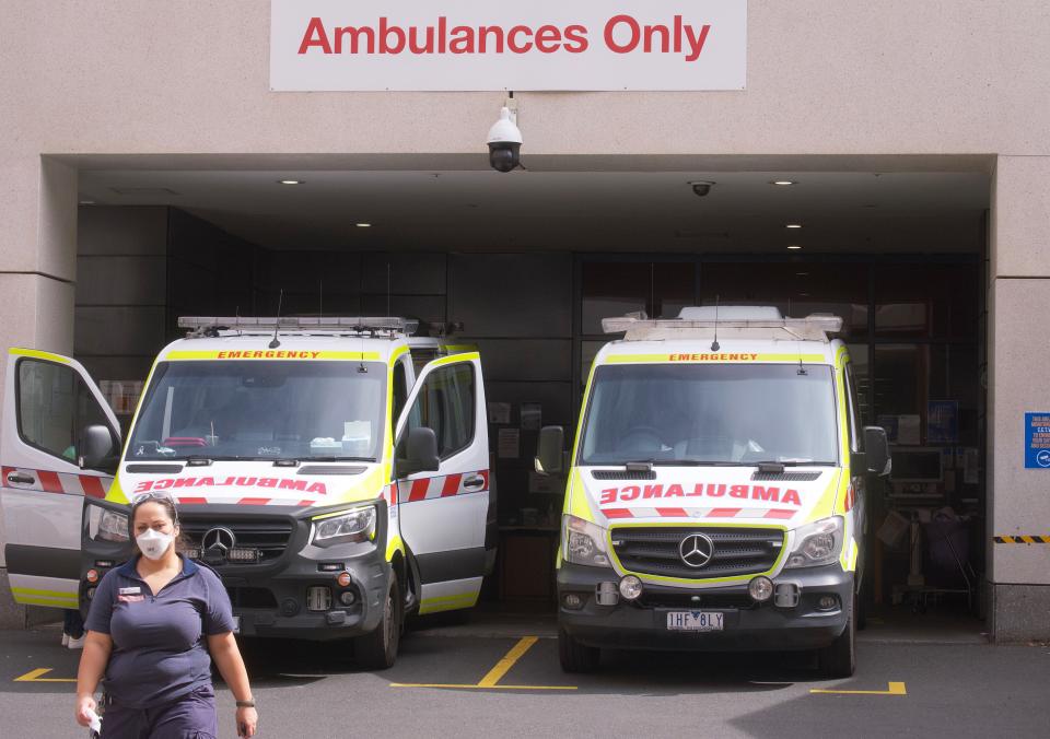 Paramedics are seen tending to their ambulance outside St. Vincent hospital in Melbourne on Tuesday. Source: AAP