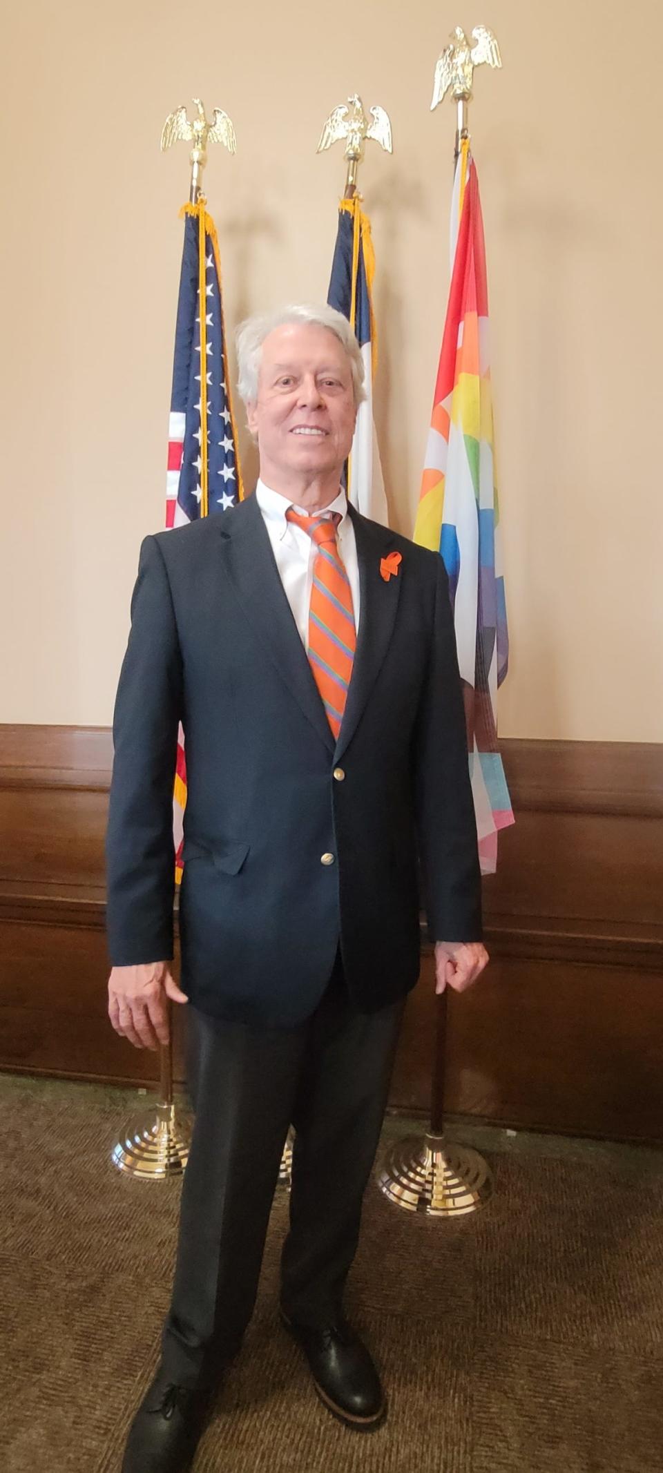 Des Moines Mayor Frank Cownie wore a pin that said "End gun violence" as he called for tougher federal gun control laws at Monday's City Council meeting.