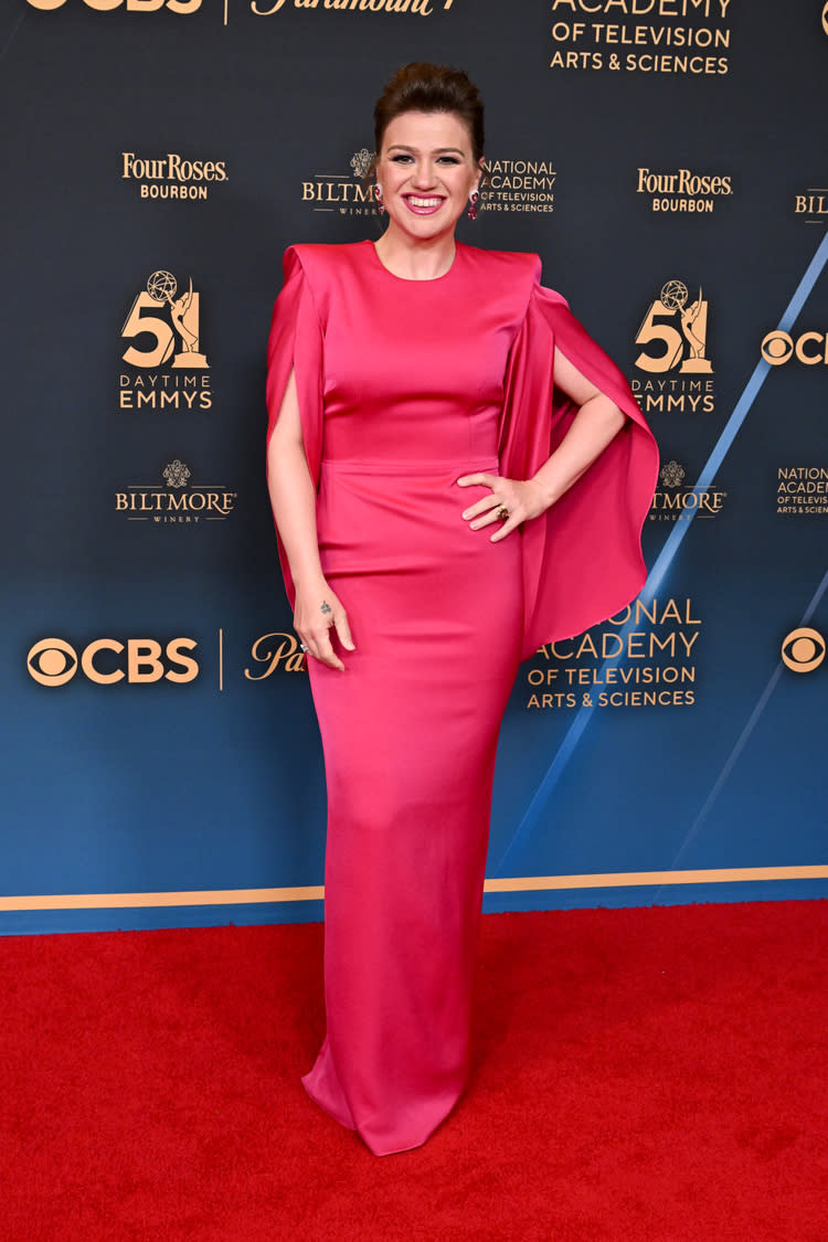 Kelly Clarkson in Alex Perry gown at the 51st Daytime Emmy Awards held at The Westin Bonaventure Hotel on June 7, 2024 in Los Angeles, California. Hot pink fitted dress, gown with cape