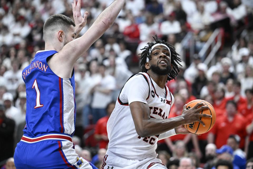 Texas Tech forward Warren Washington attempts to shoot against Kansas center Hunter Dickinson (1) during the first half of an NCAA college basketball game, Monday, Feb. 12, 2024, in Lubbock, Texas. (AP Photo/Justin Rex)