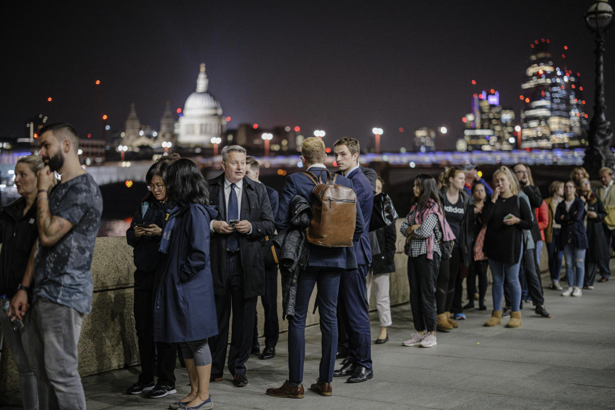 LONDON, ENGLAND - SEPTEMBER 14: People stand in line along Southbank as tens of thousands join queues to see Queen Elizabeth II lying in state at Westminster Hall on September 14, 2022 in London, England. Elizabeth Alexandra Mary Windsor was born in Bruton Street, Mayfair, London on 21 April 1926. She married Prince Philip in 1947 and acceded to the throne of the United Kingdom and Commonwealth on 6 February 1952 after the death of her Father, King George VI. Queen Elizabeth II died at Balmoral Castle in Scotland on September 8, 2022, and is succeeded by her eldest son, King Charles III. (Photo by Rob Pinney/Getty Images)