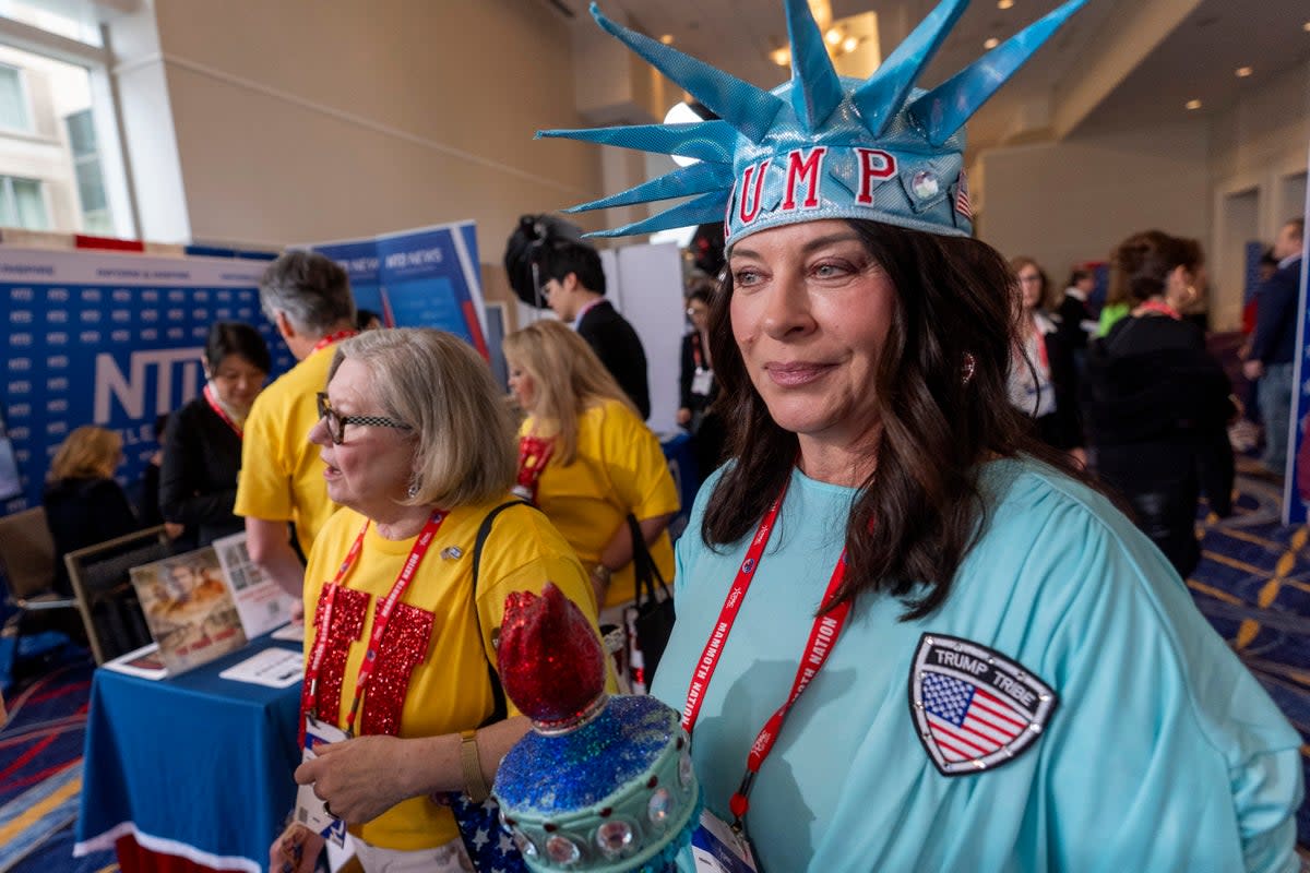 An attendee is dressed as the Statue of Liberty as she walks through the Conservative Political Action Conference, CPAC 2024, at the National Harbor in Oxon Hill, Md., Friday, Feb. 23, 2024 (AP)