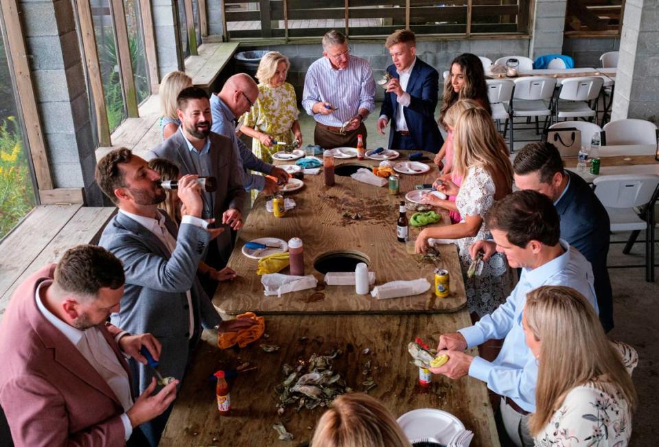 Bowen’s Island Restaurant hosts an oyster roast event for a wedding rehearsal party with some of the season’s first oysters from the Folly River near Charleston, S.C. Oct. 8, 2021.