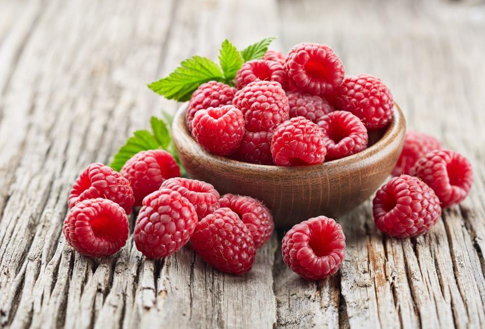 close up of raspberries on wooden table,united states,usa