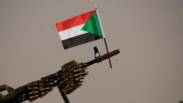 A Sudanese national flag is attached to a machine gun of Rapid Support Forces (RSF) soldiers in 2019