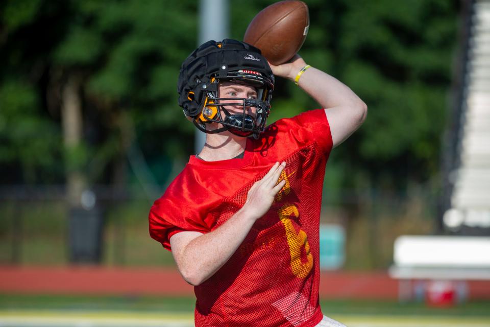 Aaron Van Trease throws the ball during football practice at St. John Vianney High School in Holmdel on Aug. 10, 2022. A month later, a game injury would leave him paralyzed in his lower body.