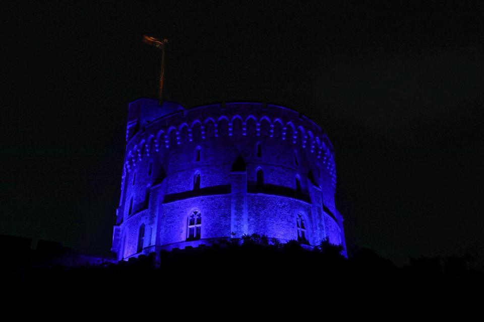 As part of the NHS birthday celebrations The Round Tower at Windsor Castle is illuminated blue on Friday evening (PA)