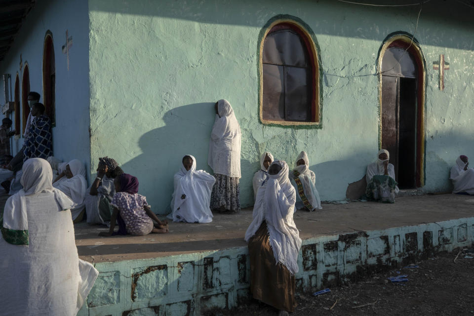 Tigrayan women who fled the conflict in Ethiopia's Tigray region, pray during Sunday Mass at a church, near Umm Rakouba refugee camp in Qadarif, eastern Sudan, Nov. 29, 2020. (AP Photo/Nariman El-Mofty)