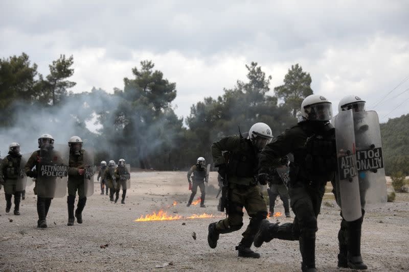 Riot police charge at demonstrators who oppose the building of a new closed migrant detention centre during clashes in the area of Diavolorema on the island of Lesbos