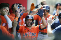 Houston Astros' Jose Altuve, center, celebrates his two-run home run with teammates during the seventh inning of a baseball game against the Los Angeles Angels, Sunday, Sept. 4, 2022, in Anaheim, Calif. (AP Photo/Jae C. Hong)