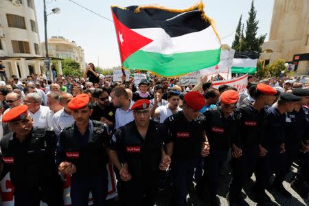 Protestors hold a Jordanian flag and chant slogans during a demonstration near the Israeli embassy in Amman, Jordan July 28, 2017. REUTERS/Muhammad Hamed