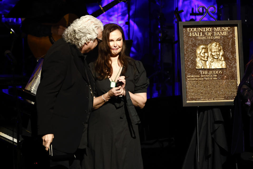 Ricky Skaggs presents Ashley Judd the medallion that would have been given to her mother Naomi Judd, who died unexpectedly a day earlier, during the Medallion Ceremony at the Country Music Hall of Fame on Sunday, May 1, 2022, in Nashville, Tenn. (Photo by Wade Payne/Invision/AP)