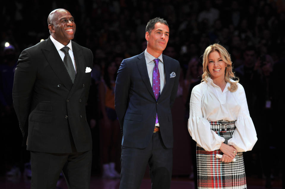 LOS ANGELES, CA - DECEMBER 18: (L-R) Magic Johnson, Rob Pelinka and Jeanie Buss attend Kobe Bryant's jersey retirement ceremony during a basketball game between the Los Angeles Lakers and the Golden State Warriors at Staples Center on December 18, 2017 in Los Angeles, California.  (Photo by Allen Berezovsky/Getty Images)