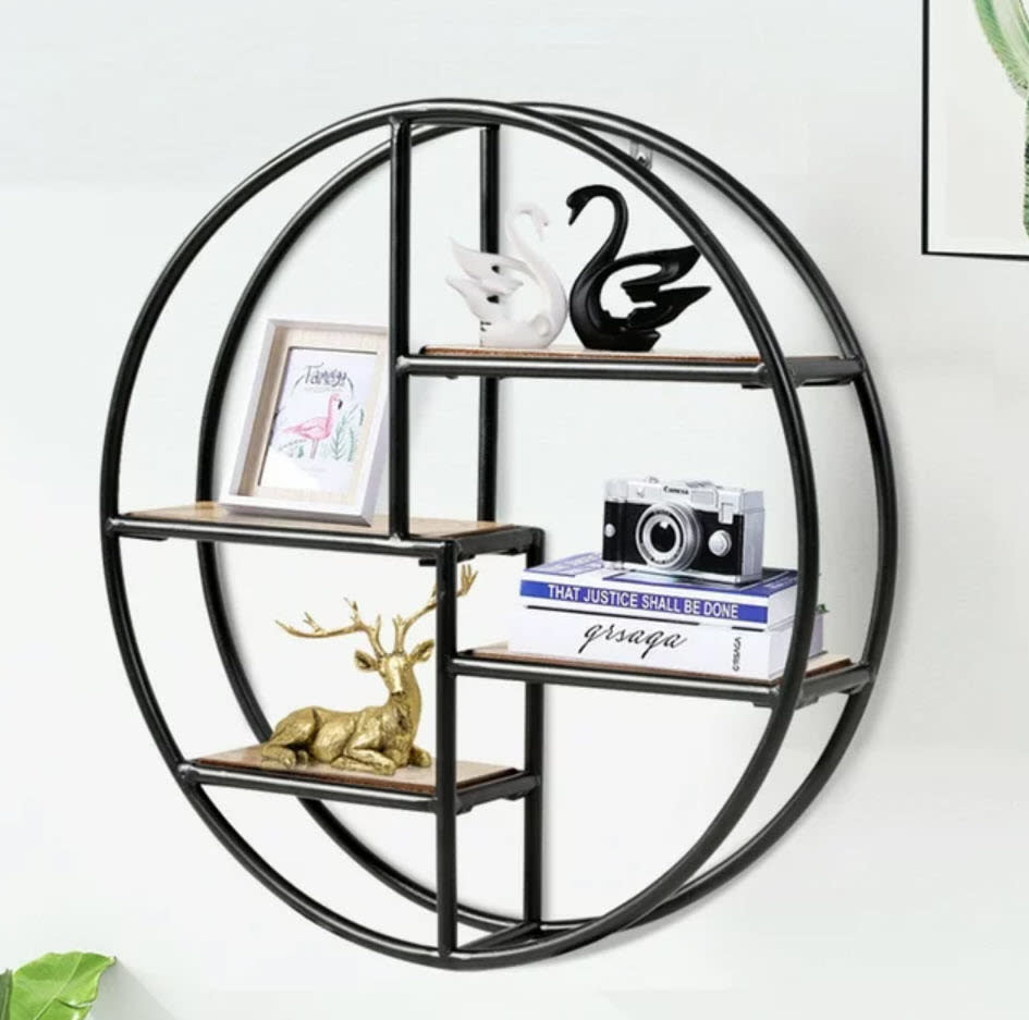 multi-shelved circular black wall hanging