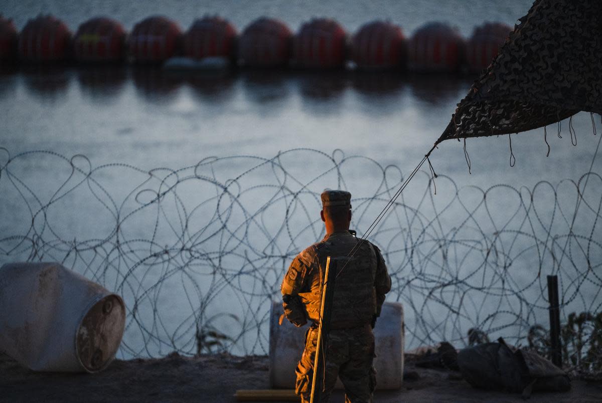 A soldier with the South Dakota National Guard stands near the banks of the Rio Grande in Eagle Pass in September 2023.