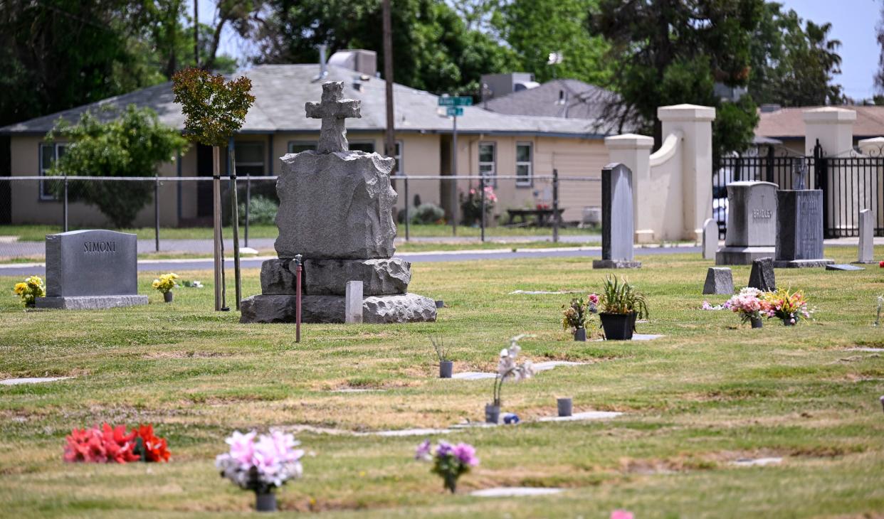 Visalia Public Cemetery with 919 N Turner Street in the background on Monday, May 1, 2023. 