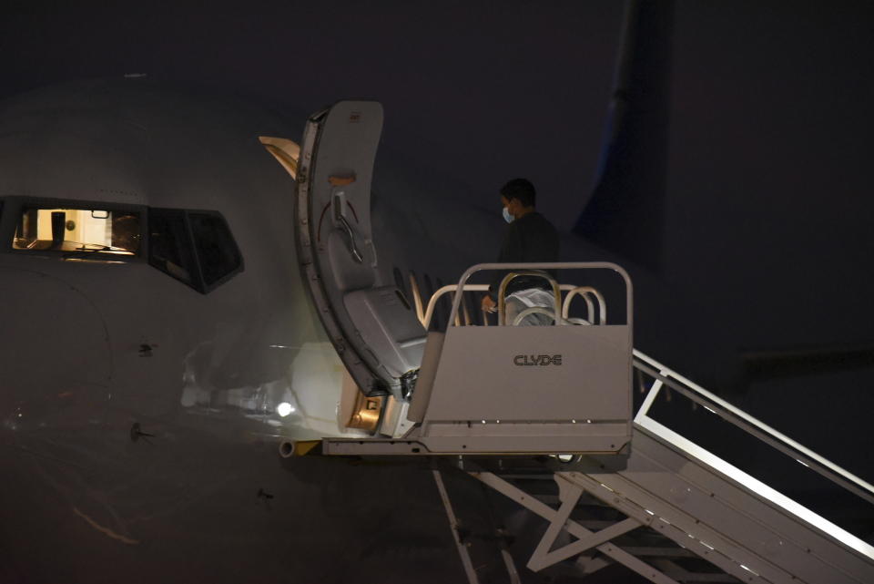 Venezuelan migrants board a plane heading back to their home country from Harlingen, Texas, on Wednesday, Oct. 18, 2023. U.S. immigration officials say passengers chosen for the deportation flight included recent arrivals as well as migrants who have committed crimes in the U.S. (AP Photo/Valerie Gonzalez)