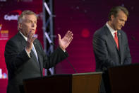 Virginia Democratic gubernatorial candidate and former Gov. Terry McAuliffe, left, and Republican challenger, Glenn Youngkin, participate in a debate at Northern Virginia Community College, in Alexandria, Va., Tuesday, Sept. 28, 2021. (AP Photo/Cliff Owen)