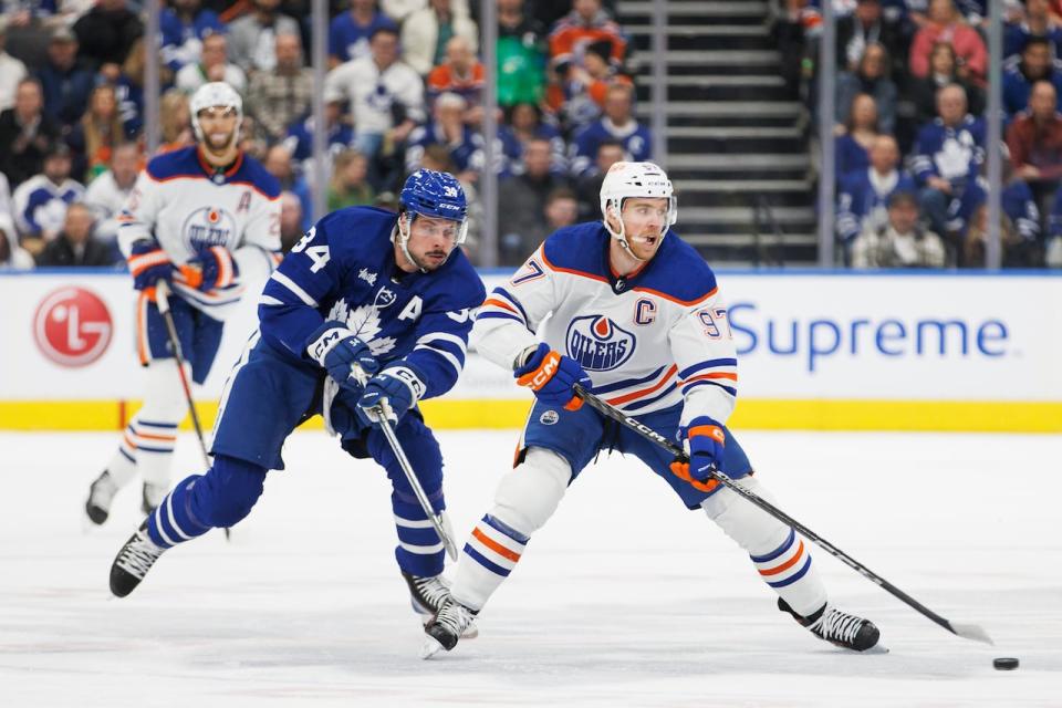 Toronto's Auston Matthews chases Edmonton's Connor McDavid during a March game. On Thursday, Rogers announced an agreement with Amazon to air Monday night games exclusively on Prime Video for the next two years.