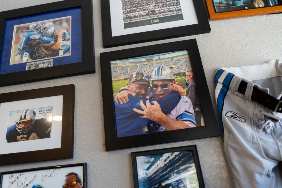 A photo of Detroit Lions superfan Donnie "Yooperman" Stefanski, left, hugging Detroit Lions superfan Ron "Crackman" Crachiola is posted on a wall alongside other memorabilia at Yooperman's Bar & Grill in Goetzville on Wednesday, Aug. 30, 2023.