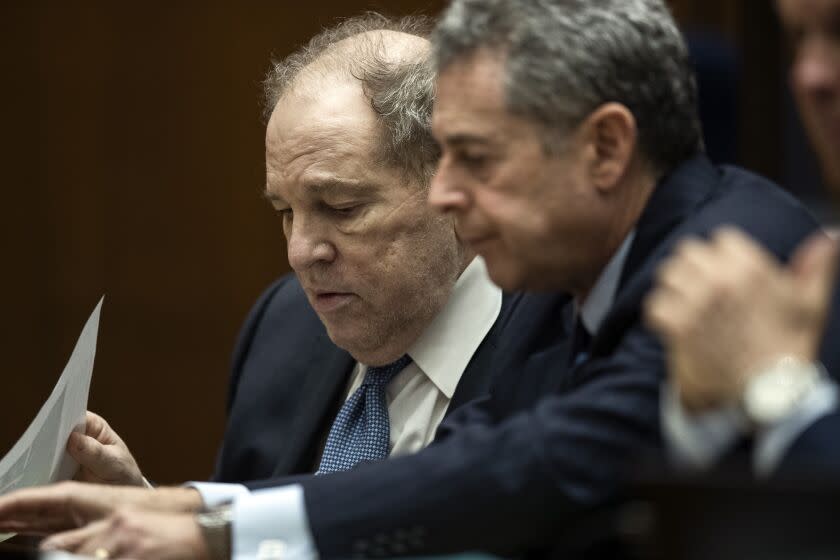 Former film producer Harvey Weinstein, left, interacts with his attorney Mark Werksman in court at the Clara Shortridge Foltz Criminal Justice Center in Los Angeles, Calif., on Tuesday, Oct. 4 2022. (Etienne Laurent/Pool Photo via AP)