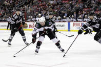 Arizona Coyotes center Travis Boyd (72) looks to pass around New Jersey Devils defenseman Jonas Siegenthaler (71) during the second period of an NHL hockey game Wednesday, Jan. 19, 2022, in Newark, N.J. (AP Photo/Adam Hunger)