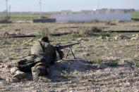 A member of Iraq's Popular Mobilisation units holds a position on the outskirts of the town of Ad-Dawr, on March 6, 2015, during a military operation to retake the Tikrit area from the Islamic State group