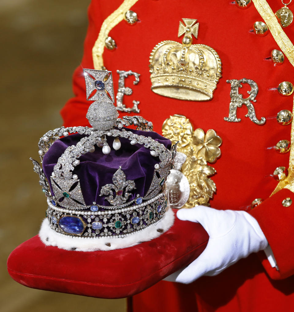 The Imperial State Crown is carried on a cushion as it arrives for the State Opening of Parliament, at the Houses of Parliament in London, Wednesday, May 8, 2013. The State Opening of Parliament marks the formal start of the parliamentary year, the Queen will deliver a speech which will set out the government's agenda for the coming year. (AP Photo/Kirsty Wigglesworth, Pool)