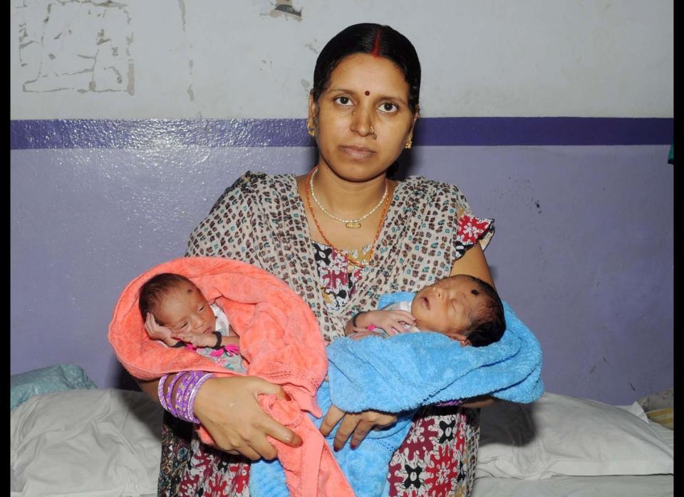 Rinku Devi, 28, with her one-week-old sons (yet to be named) at the Mati Sadan Parijat Nursing Home on August 5, 2011 in Muzaffarpur district of Bihar, India.     An Indian woman with two wombs has given birth to two boys, one from each uterus. Delighted mum Rinku Devi delivered her one-in-fifty-million babies last Friday (29 July) in the northern city of Patna. Stunned doctors said giving birth to healthy babies conceived in different ovaries is so rare an average of one case is reported each year anywhere in the world. The babies, however, are not twins, as they were conceived at different times. According to gynaecologist Dr. Dipti Singh, "Rinku Devi suffers from a rare medical condition known as the uterus didelphys in which the womb develops in two parts, each with its own fallopian tube. It is quite a rare congenital condition and less than 100 women around the world are known to have it." Rinku's condition was not diagnosed until she went into labor, but after a one-hour-long surgery, she gave birth to two little boys weighing 2 kilograms and 1.5 kilograms respectively.